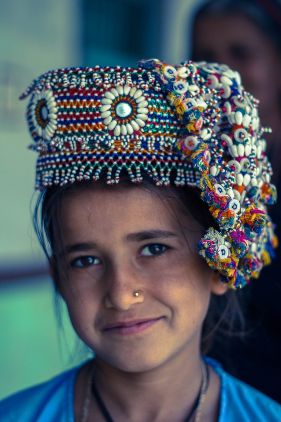 A beautiful Kutchh girl donning traditional beaded accessory used for balancing earthenwares while carrying potable water; they dont make it anymore.